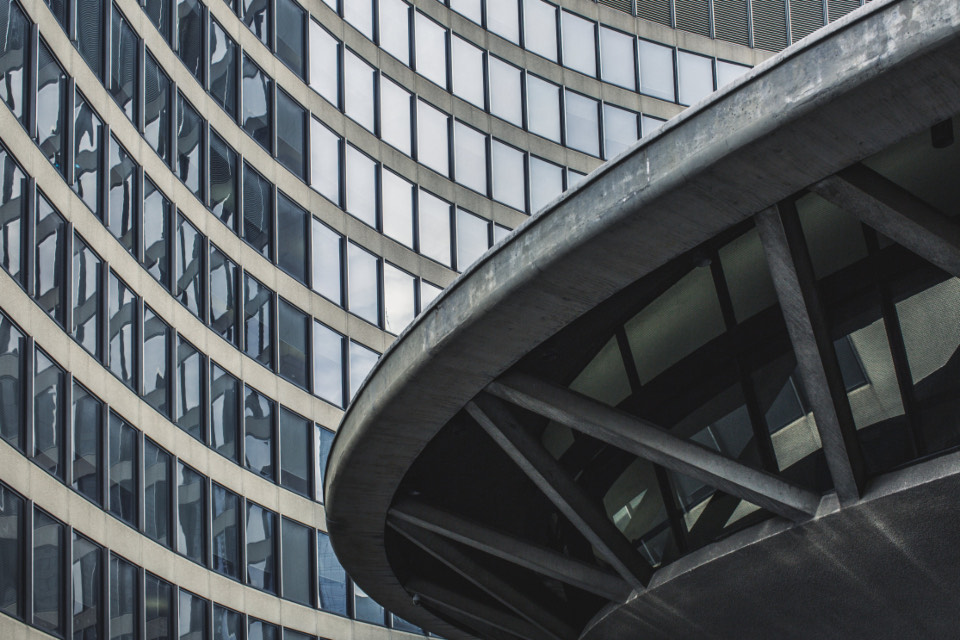 A curved building facade, the horizontal bands bending away out of frame.